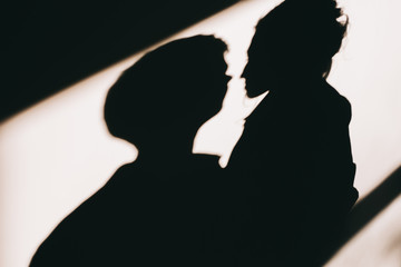 shadow of a man, shadow of a couple on the wall