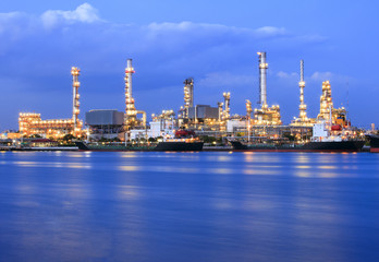 ship port and oil refinery plant with blue river on twilight time