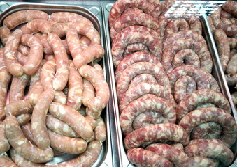 Handmade sausages are on display in a supermarket.
