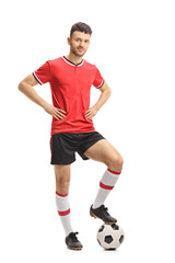 Fototapeta na wymiar Soccer player posing with a football