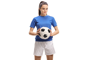 Female soccer player holding a football