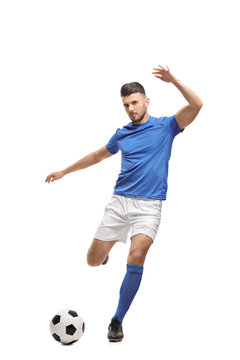 Fototapeta Soccer player kicking a football