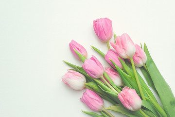 Top view of first spring bouquet of pink tulips on white background with copy space. Beautiful spring background for International Womens day, Mother's day, March 8, Valentines day