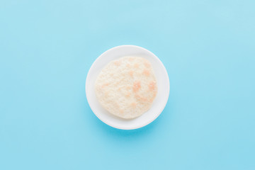 top view of plate with matza isolated on blue, Passover Tale concept