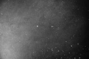 Black and gray gradient texture with small white drops and scratches