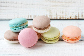cakes macarons on wooden background
