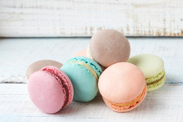 cakes macarons on wooden background