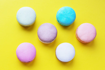 cakes macaroons on a yellow background
