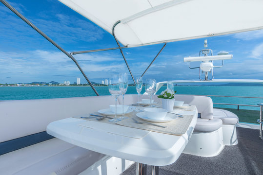 Fototapeta Luxury lunch table setting on a yacht interior comfortable design for holiday recreation tourism travel and vacation concept
