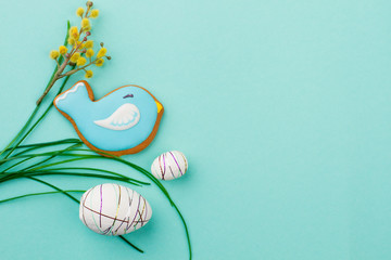 Beautiful Easter spring composition. Styrofoam decorative eggs and pussy willow twigs. Bird shaped Easter cookie and grass, copy space.
