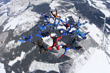 Formation skydiving. Skydivers are in the sky.