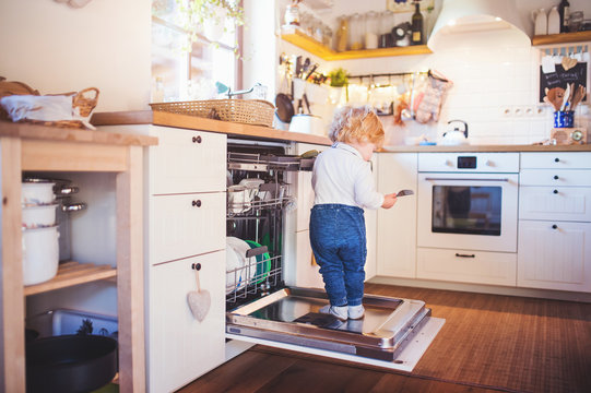 Toddler Boy In Dangerous Situation At Home. Child Safety Concept.