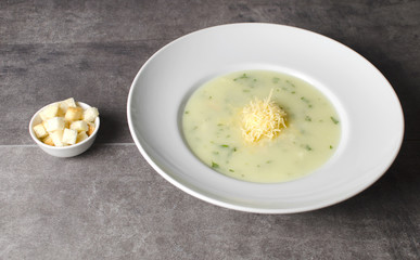 Cheese chicken soup with croutons in a white plate