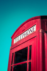 Vintage Red British Traditional Telephone Booth With Blue Sky and Copy Space