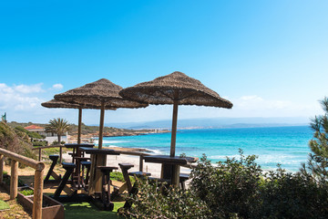 tables and stools under parasols