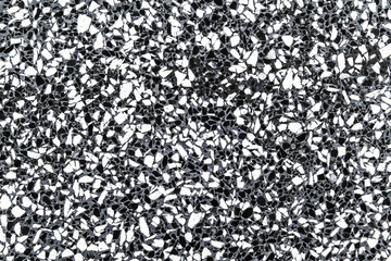Monochrome grainy mineral surface background.