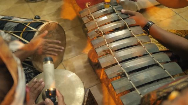 Asian Man Playing Traditional Saron Javanese Gamelan Musical Instruments and Drums in Temple. Ubud, Bali, Indonesia. 4K.