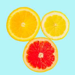 Citrus on a blue pastel background. Grapefruit, lemon and orange in a cut. View from above