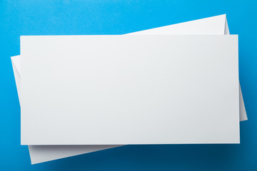 White postal envelope or DL flyer on a blue background.