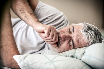 Fototapeta na wymiar Senior man in bed.