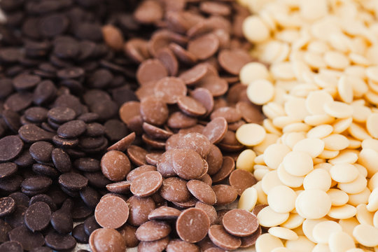 An assortment of fine white, dark, and milk chocolate in drops