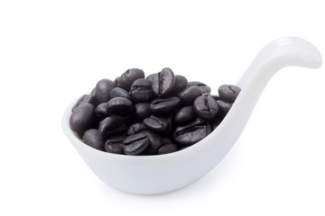 coffee beans in ceramic spoon isolated clipping path.