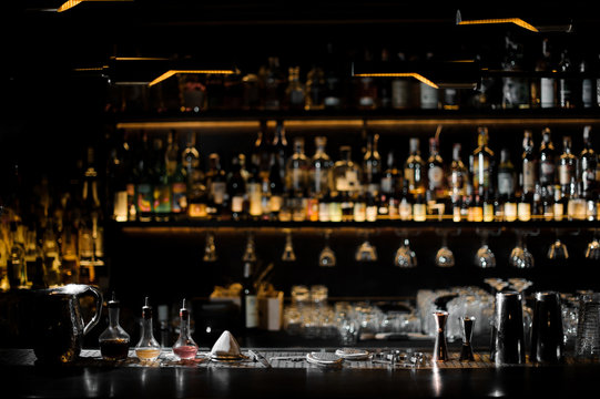 Blurred background of dark bar with barman essentials