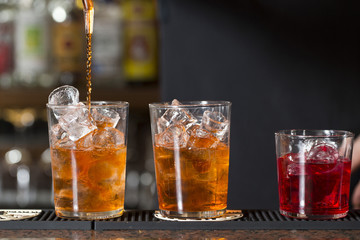three cocktails on the bar counter