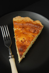 Homemade Delicious sweet Cottage Cheese, Vanilla Pie with cut out Slices on Black Slate, view from Above.