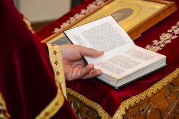 Naklejka premium Belgrade, Serbia - November 11, 2017: The priest reads a prayer