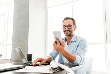 Handsome mature man using mobile phone