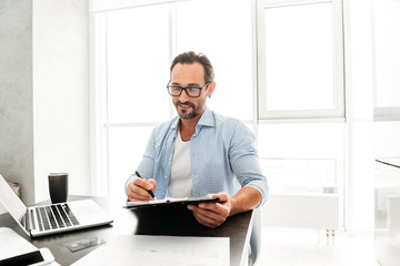 Fototapeta premium Handsome mature man working with documents