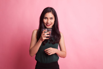 Young Asian woman with a glass of drinking water.