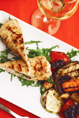 ROLLED CHICKEN WITH BACON served on a table with a glass of wine
