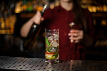 Delicious cocktail on the background of barman girl