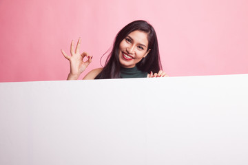 Fototapeta premium Young Asian woman show OK with blank sign.