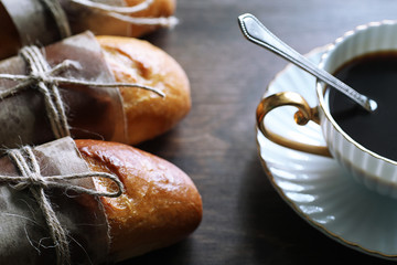 Fototapeta premium Freshly baked French baguette on a wooden table