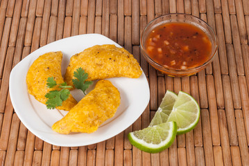 Colombian empanada with spicy sauce