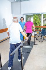 Fototapeta na wymiar Elderly people at gym in rehab facility