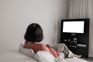 Close up and selective focus of teenage girl watching blank  televistion in living room at home in vacation time.