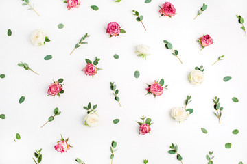 Floral pattern made of red and white rose flower buds and eucalyptus branches on white background. Fat lay, top view flowers composition.