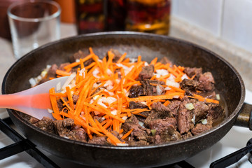 Beef stew with vegetables in frying pan