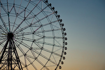 Ferris wheel silhouette against the sunset to use as background