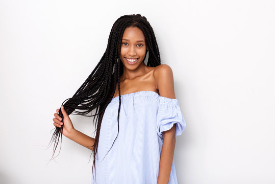 beautiful african american woman with braided hair smiling against white background