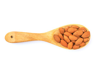 Almonds in the wooden spoon  isolated on white background with clipping path.