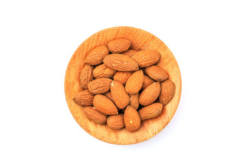 Almonds in the wooden bowl isolated on white background with clipping path.