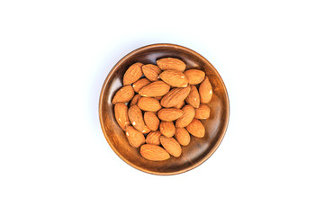 Almonds in the wooden bowl isolated on white background with clipping path.