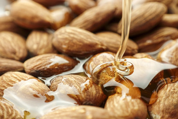 Pouring honey on almond