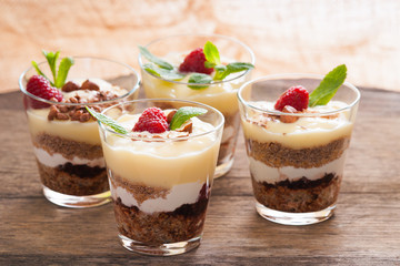 Dessert with berries, jelly, cream, nuts and mint leaf 