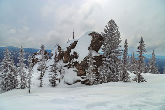 Huge stone of unusual shape on Mount Utuya. Winter landscape in Altay Mountains.  Russia, Kemerovo region, Sheregesh ski resort, March 2018.